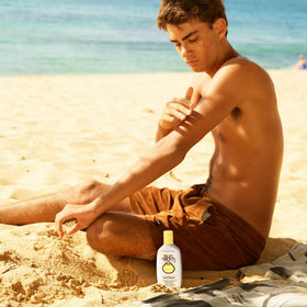 Sun Bum cream being applied to arm outdoors to show cooling relief after sun