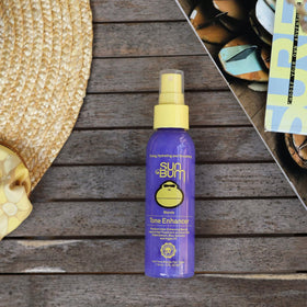 Sun Bum being applied to towel-dried hair, tones and conditions strands