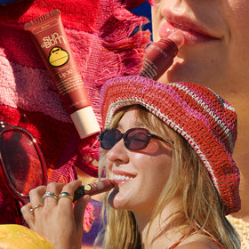 Sun Bum Bonfire in hand for scale demonstrating travel-friendly size benefit