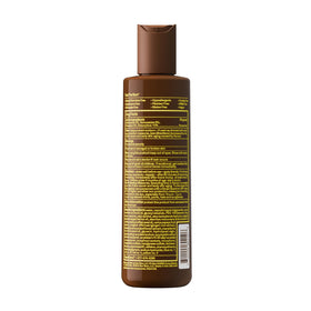 Sun Bum bottle on beach towel showing travel-friendly, reef-safe benefit