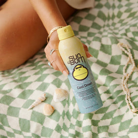 Fine mist from Sun Bum Cool Down on forearm demonstrating fast absorption and cooling effect