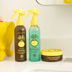 Sun Bum spray held in hand for scale showing compact 6 oz design easy for travel and touchups