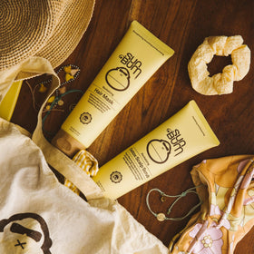 Sun Bum in hand usage demonstrates application and precise scalp targeting benefit