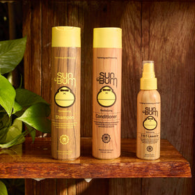 Sun Bum in-use on beach waves providing UV protection and frizz control