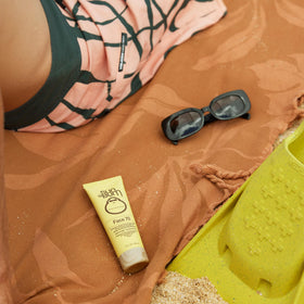 Sun Bum label close-up showing reef-safe and ingredient omission benefits