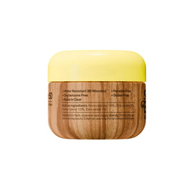 Sun Bum lifestyle beach use with model applying sunscreen for outdoor protection