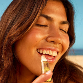 Sun Bum lip balm cap off close-up texture showing smooth moisturizing glide