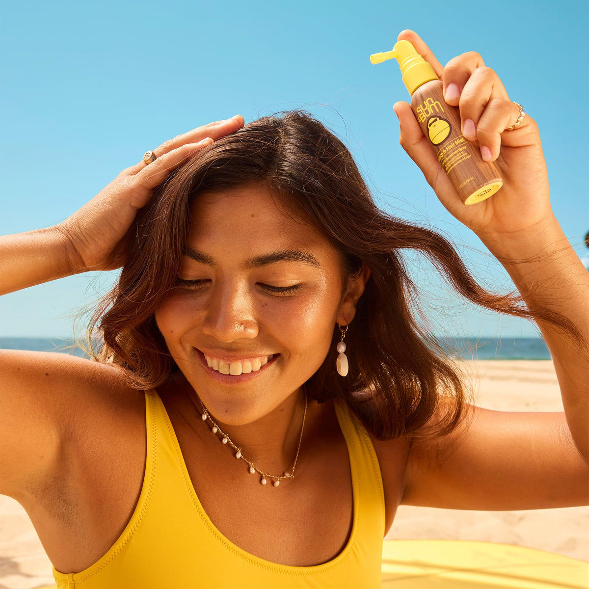 Sun Bum 2 oz bottle held in hand illustrating compact travel convenience