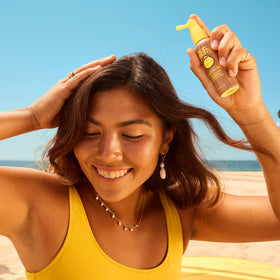 Sun Bum 2 oz bottle held in hand illustrating compact travel convenience