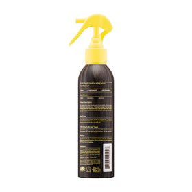 Sun Bum bottle next to everyday items showing travel-friendly size