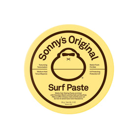 Sun Bum Sonny's surf paste in lifestyle beach scene showing sun-ready styling benefit