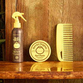 Sun Bum Sonny's surf paste next to smartphone showing 3 oz travel-friendly size