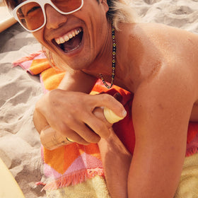 Sun Bum sunscreen texture on hand showing moisturizing, quick-dry benefit