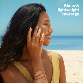 Sun Bum travel size tube in hand highlighting easy portability and on-the-go use