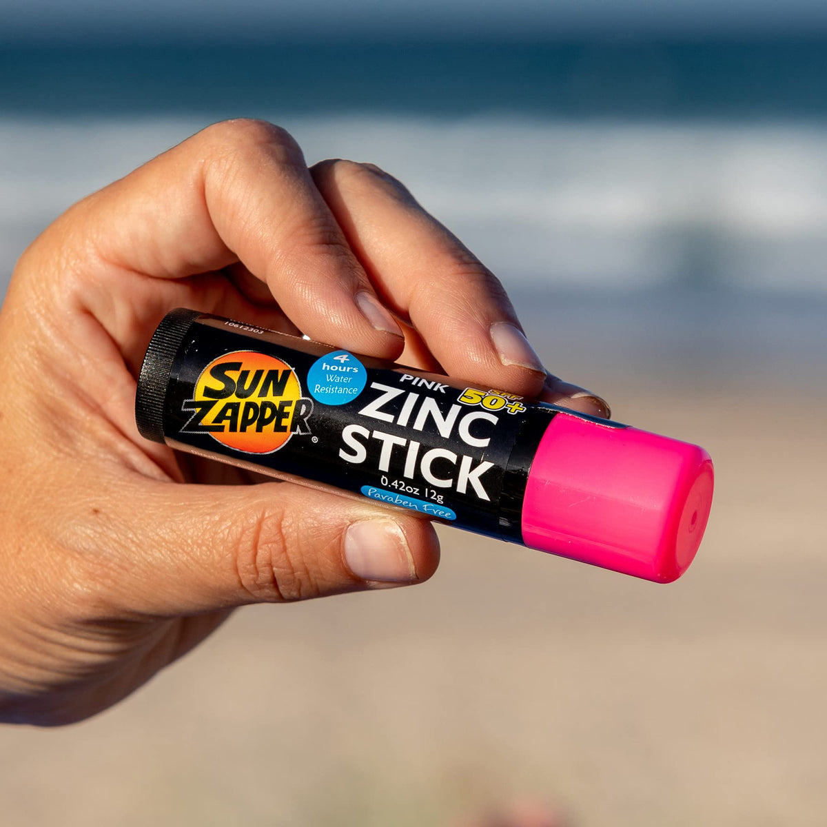 Sun Zapper beach lifestyle scene with family applying visible zinc protection