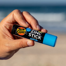 Sun Zapper size comparison next to coin illustrating travel‑friendly benefit