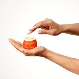 Sunday Riley cream in hand to show size and how a pea-sized amount covers face