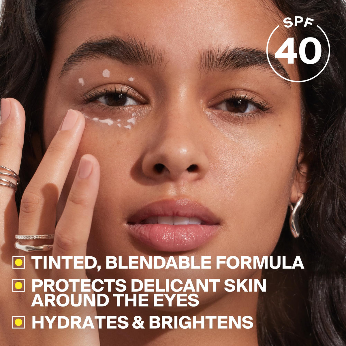 Supergoop! hand application of Bright-Eyed demonstrating easy blending and coverage