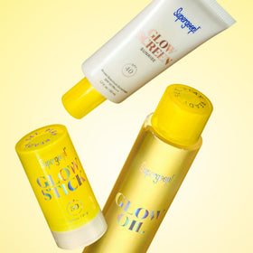 Supergoop! glow stick beside a coin showing .7 oz size and portability
