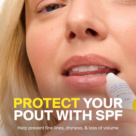 Supergoop! PLAY lip balm held in hand to show compact travel-friendly size