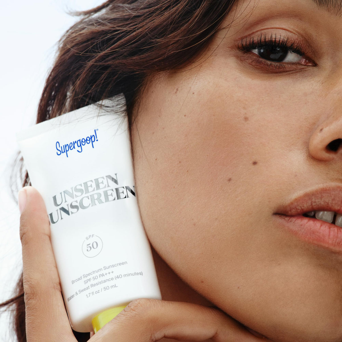 Supergoop! flatlay with travel items showing portable, on-the-go protection benefit