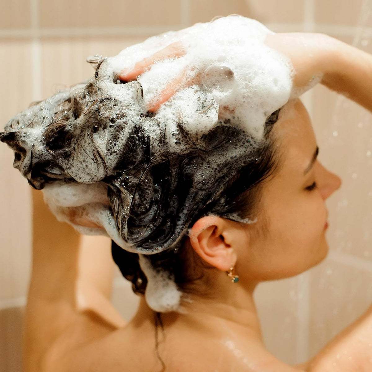 Svvimer in-use shot massaging shampoo into scalp to encourage healthier-looking strands