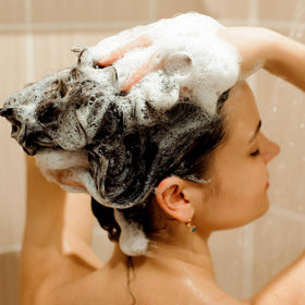 Svvimer in-use shot massaging shampoo into scalp to encourage healthier-looking strands