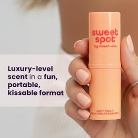 Sweetums SweetSpot Peach held in hand to show size and portability benefit