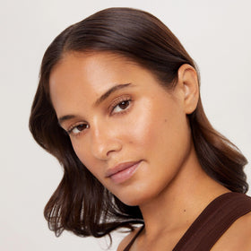 TAN-LUXE on nightstand with skincare, shows overnight routine convenience benefit