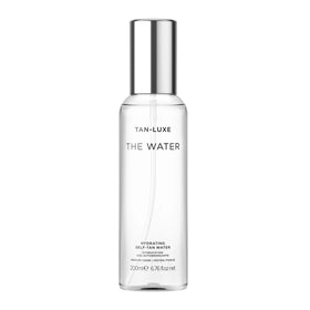 TAN-LUXE front bottle view showing sleek packaging and clear tanning water benefits