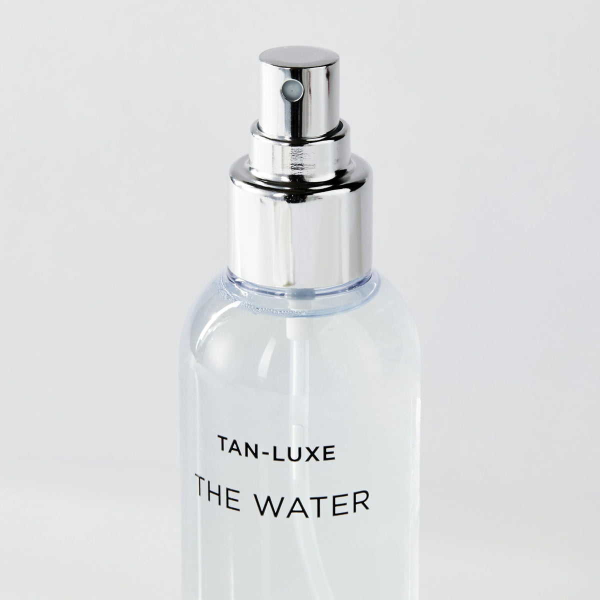 TAN-LUXE bottle staged in bathroom setting showing everyday routine compatibility