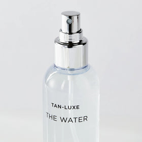 TAN-LUXE bottle staged in bathroom setting showing everyday routine compatibility
