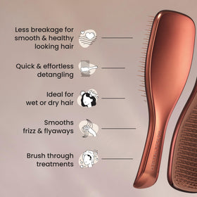 TANGLE TEEZER in hand for scale showing compact travel-friendly size