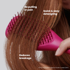 Tangle Teezer brush inside a purse, Electric Raspberry visible for quick finding