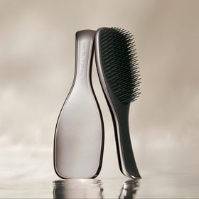 TANGLE TEEZER back profile highlighting curved body and comfortable grip for wet hands