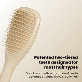 TANGLE TEEZER compact side profile highlighting ergonomic shape for comfortable grip