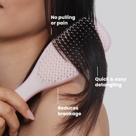 TANGLE TEEZER held in hand to show scale and comfortable ergonomic grip