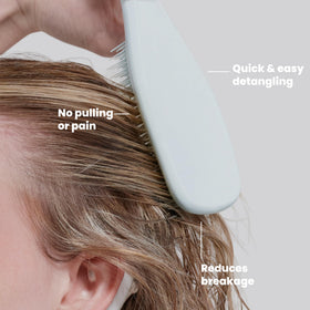Tangle Teezer held in hand to show scale and portable convenience