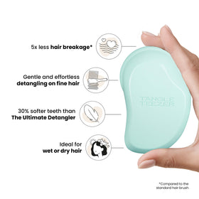 TANGLE TEEZER shown in hand demonstrating palm-friendly grip and gentle detangling benefit