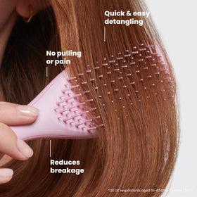TANGLE TEEZER held in hand next to wallet illustrating travel-friendly size