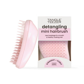 TANGLE TEEZER mini front view showing compact size and bright millennial pink finish, easy to pack