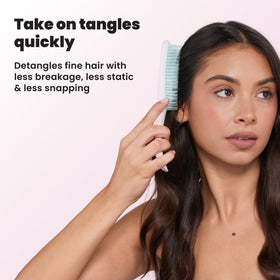 TANGLE TEEZER beside a hand for size comparison, compact travel-friendly design