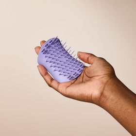 TANGLE TEEZER on bathroom shelf showing stylish lavender finish and easy-access benefit