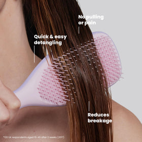 TANGLE TEEZER held in hand to show scale and large coverage for quicker detangling