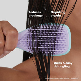 TANGLE TEEZER held in hand to show scale and convenient on-the-go use