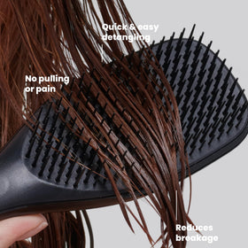 TANGLE TEEZER held in hand to show scale, easy travel-friendly brush