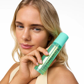 Tanologist face mist on bathroom vanity styled with skincare, integrates with routine benefit