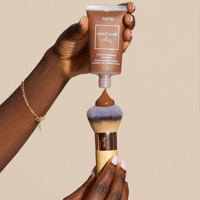 tarte brush next to foundation bottle showing size and practical scale for daily use