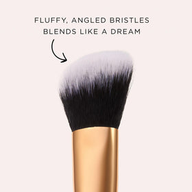 tarte brush applying concealer to undereye area for targeted coverage and natural finish