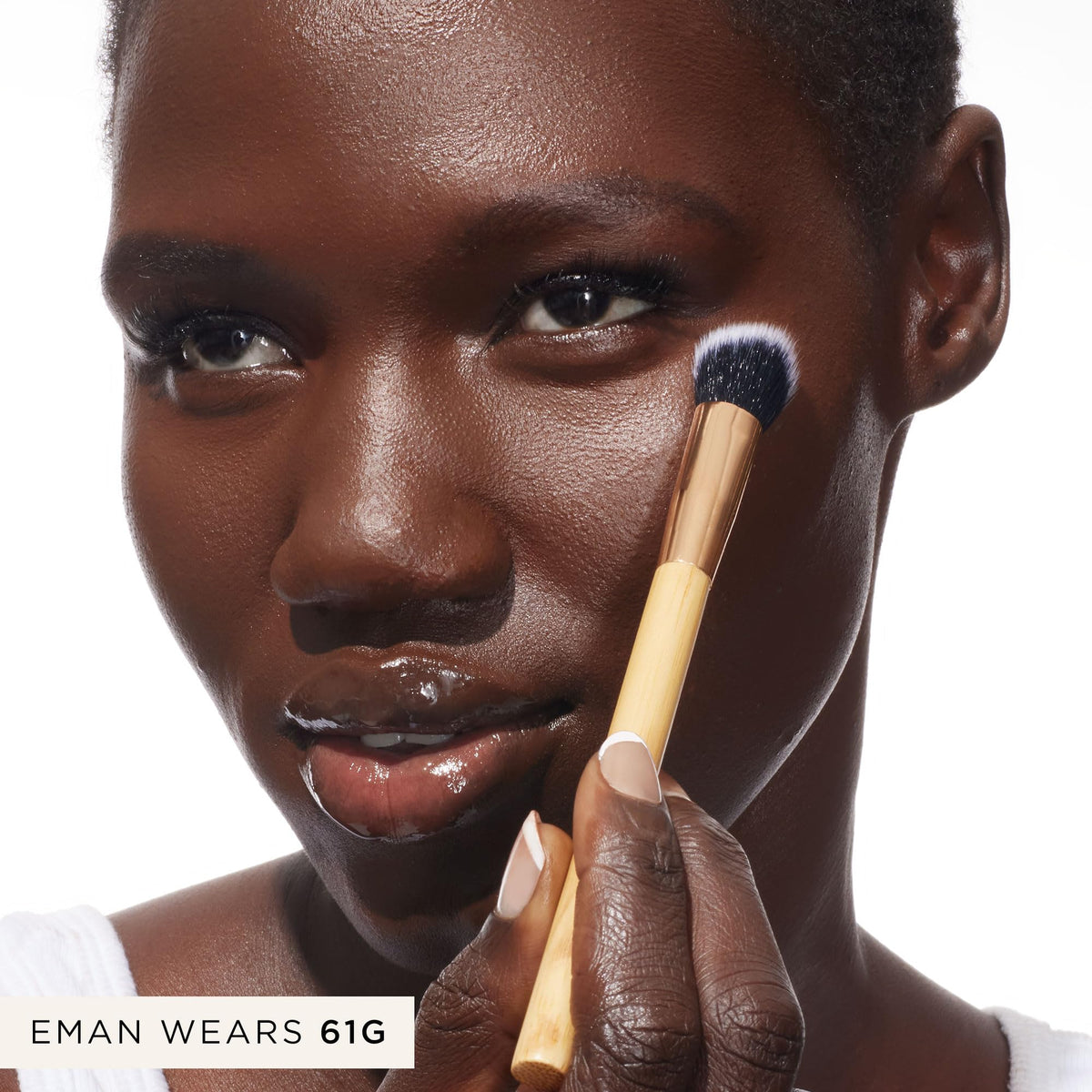 tarte brush held in hand to show scale and travel-friendly compact design